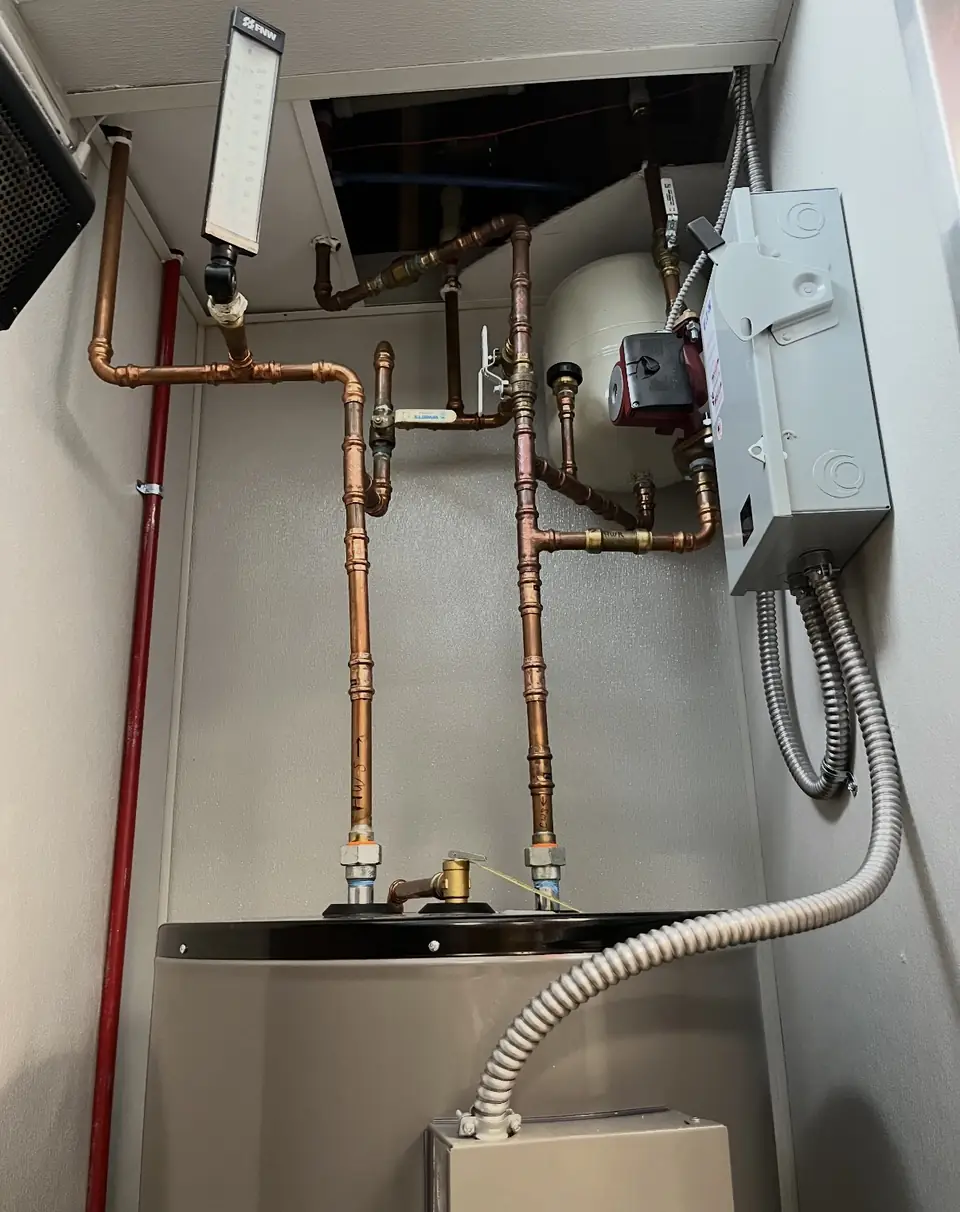 Copper water heater manifold with a red gas line, new install